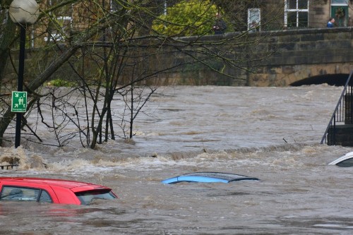 Image shows cars submerged by flood water